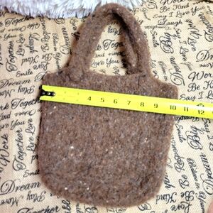 Handcrafted brown felted Wool bag has a flower applique not yet attache
